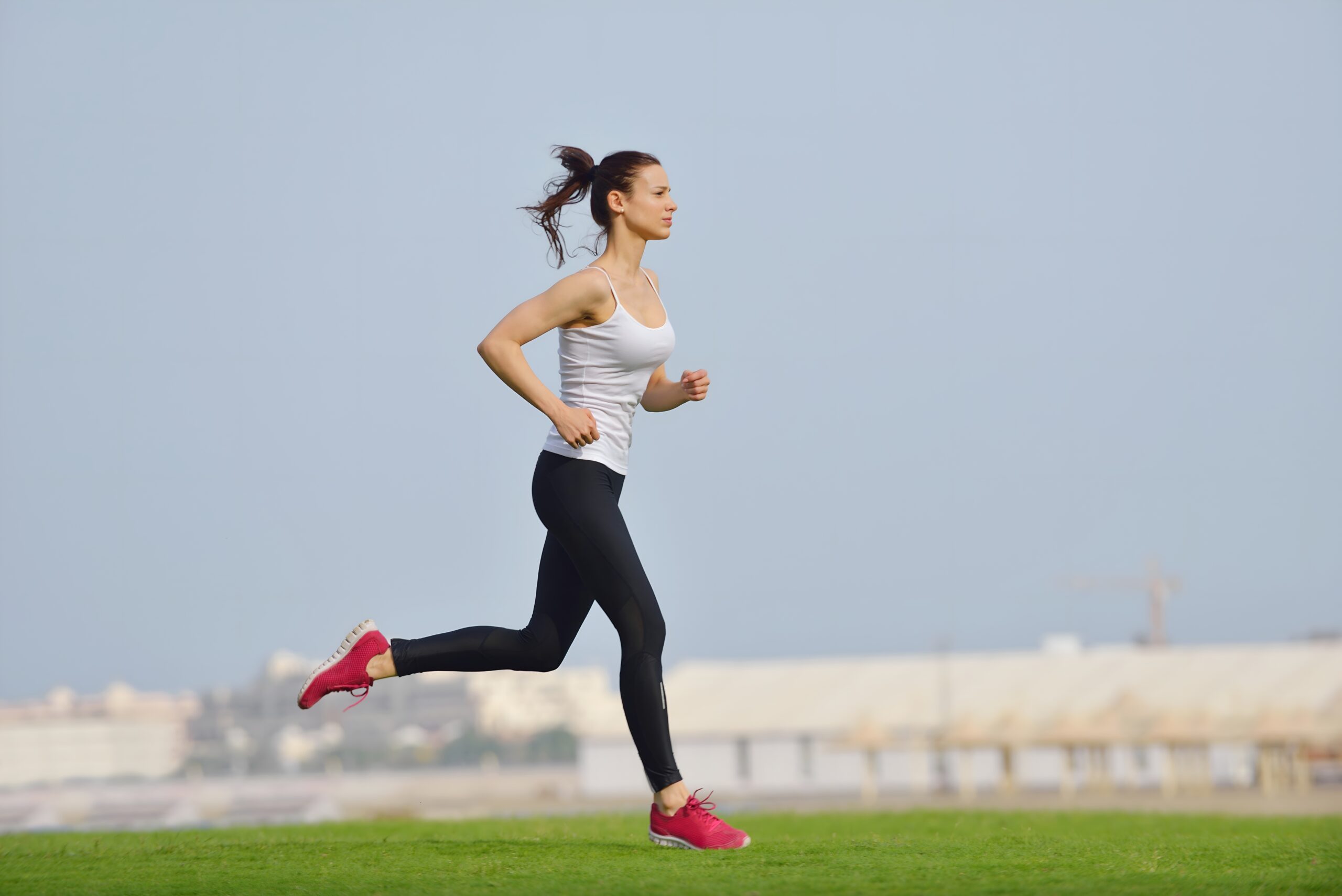 Woman jogging on green grass
